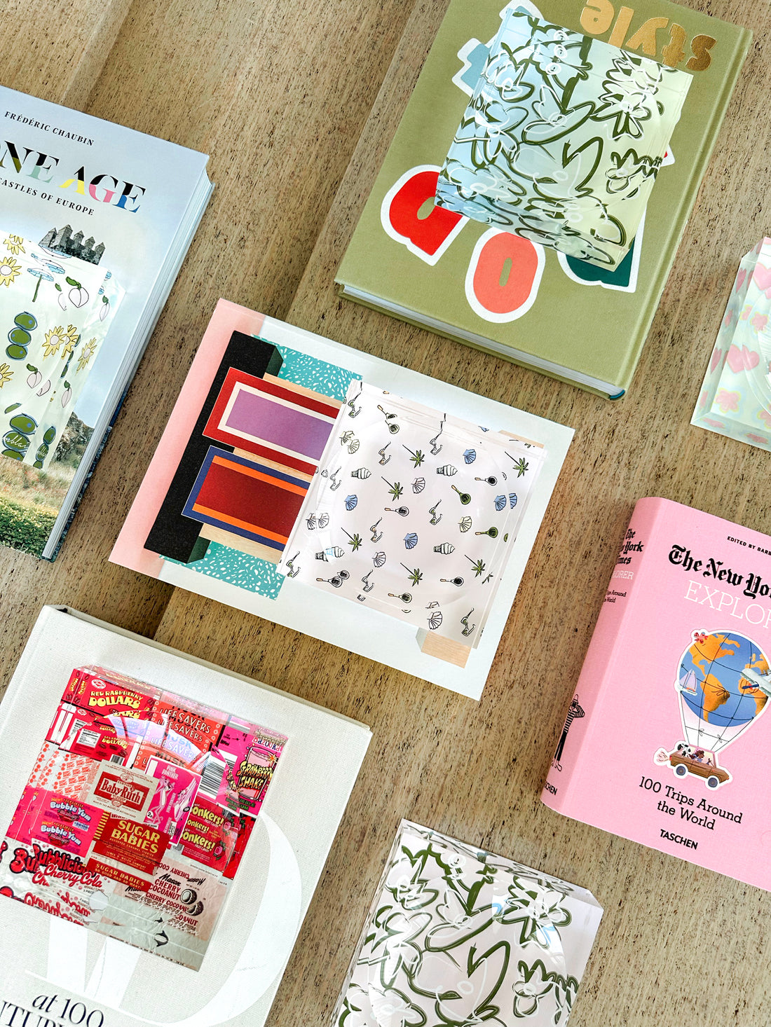 A flat lay of by robynblair prints, books and candy